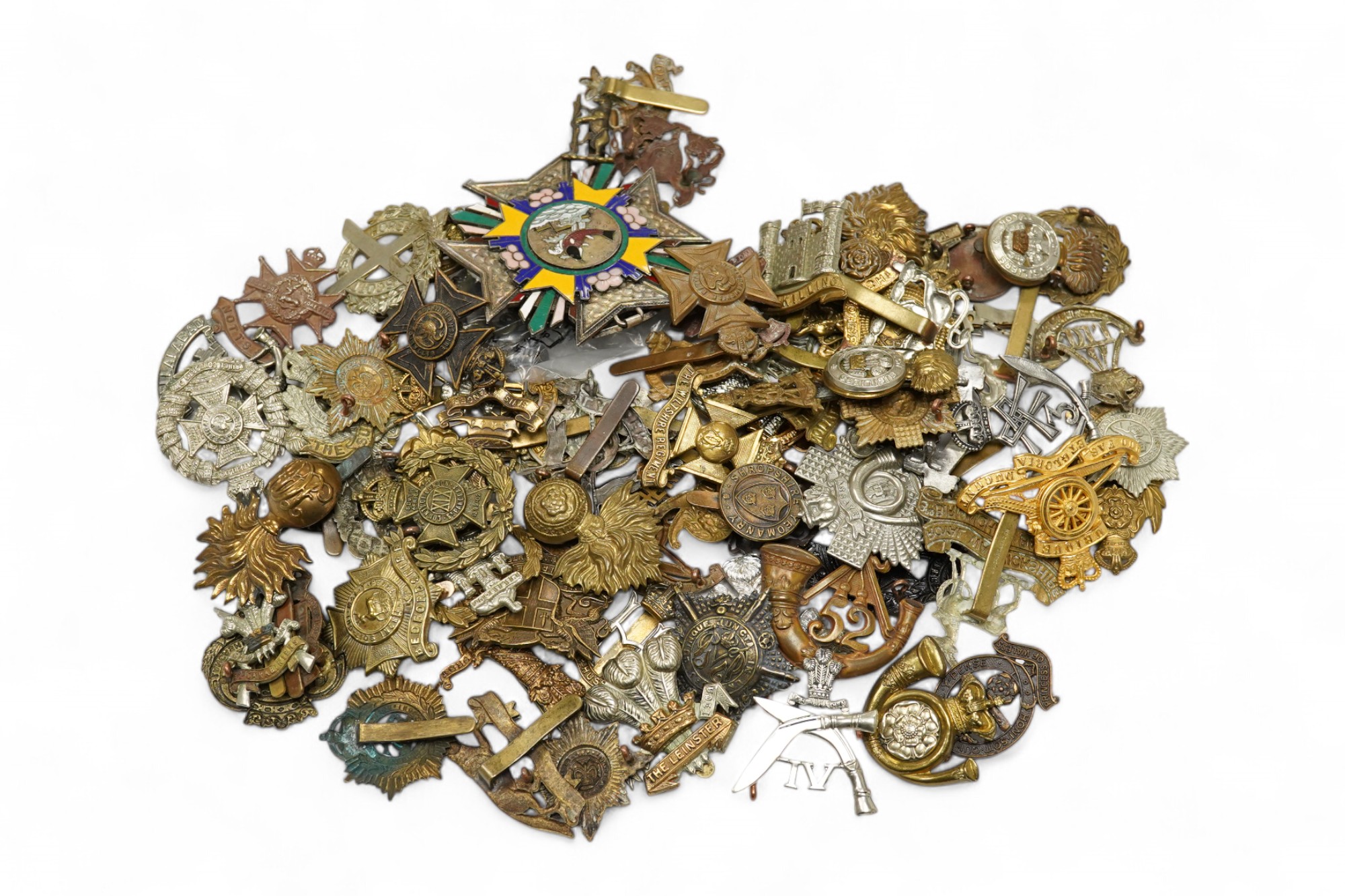 Seventy-eight military cap badges, including; the Royal Horse Artillery, the King’s Own, the Notts and Derby Regiment, the Royal Hussars, the Shropshire Yeomanry, the Herefordshire Regiment, the City of London Volunteer